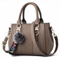 Premium Leather Messenger Bag – Intricate Floral Embroidery & Trendy Hairball Detail for Ladies