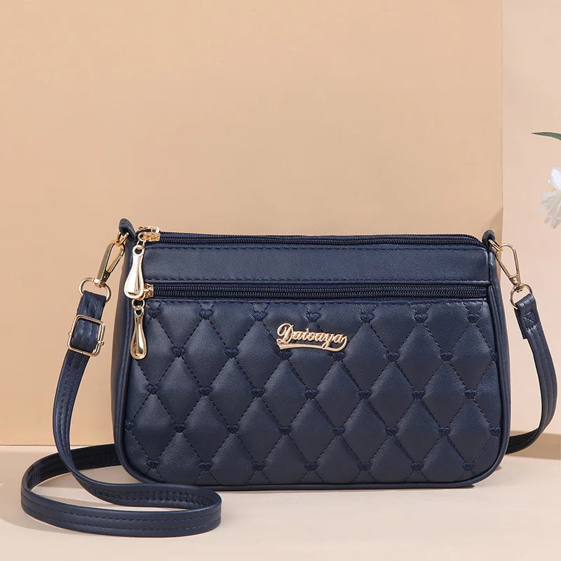 Premium Leather Messenger Bag – Intricate Floral Embroidery & Trendy Hairball Detail for Ladies