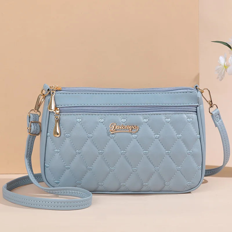 Premium Leather Messenger Bag – Intricate Floral Embroidery & Trendy Hairball Detail for Ladies