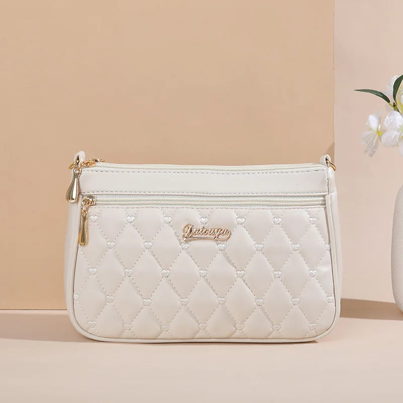 Premium Leather Messenger Bag – Intricate Floral Embroidery & Trendy Hairball Detail for Ladies